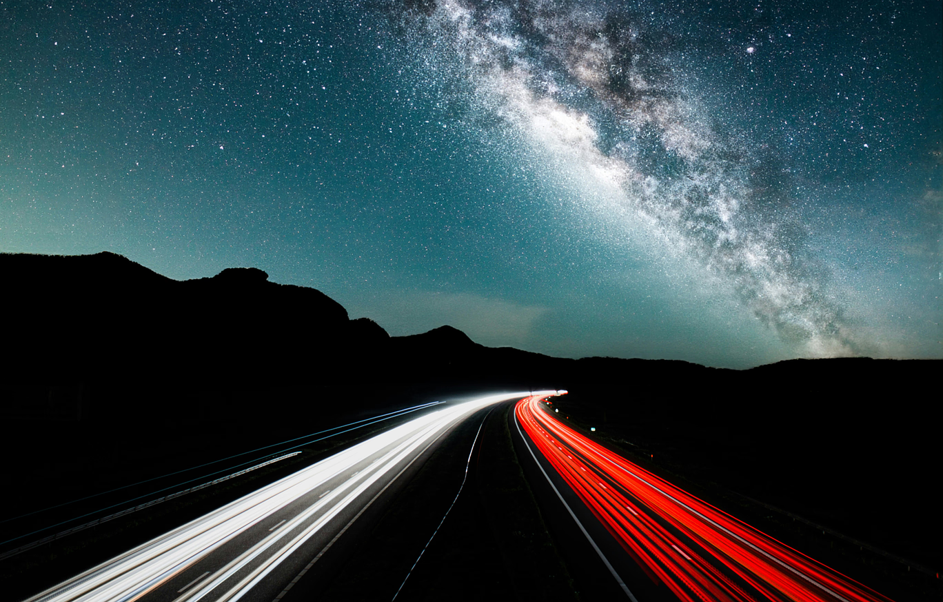 Desert road under a starry sky with the Milky Way galaxy.